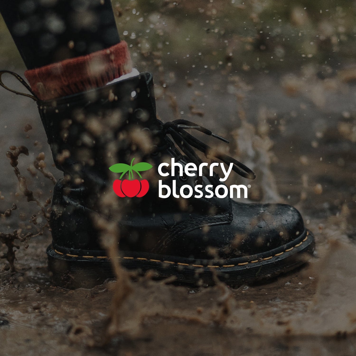 Cherry Blossom portfolio piece image showing logo and boot splashing in muddy puddle.