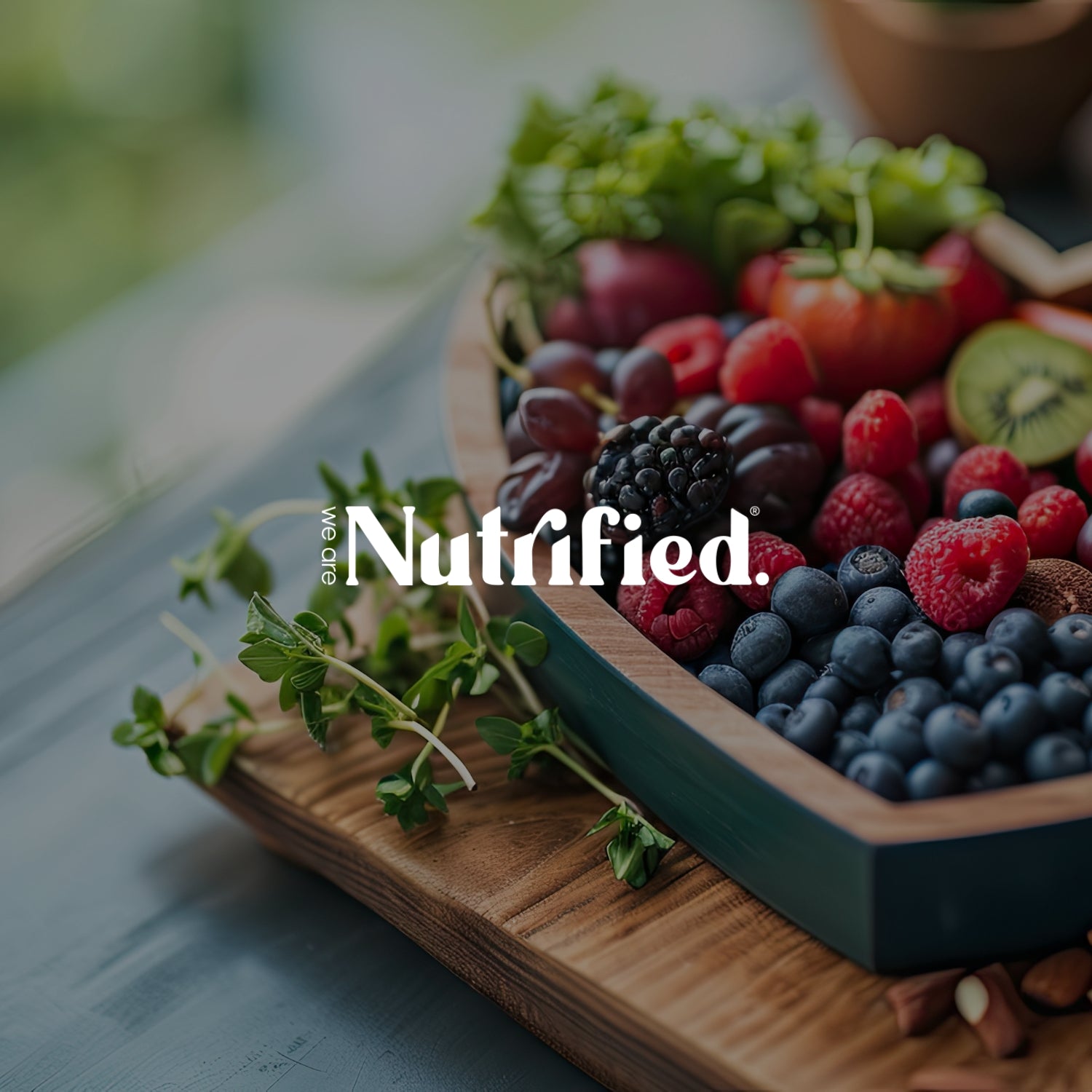 we are Nutrified portfolio piece image showing logo and selection of fruits in heart shaped wooden bowl